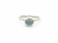 "Moss Aquamarine Ring Sterling Silver Boho Ring Le Chien Noir March Birthstone Size 8.75 This is a high domed, lovely oval moss aquamarine cabochon. I've featured it in a minimalist, sterling silver ring with a simple, round sterling shank. It's wonderful and comfy to wear and would be perfect for everyday. The \"moss\" in moss aquamarine comes from iron trace elements that give the stone a moss-like appearance. They're often a greenish-blue with mossy features in a transparent gem body. This on Modern Aquamarine Oval Rings, Aquamarine Birthstone Ring, Oval, Aquamarine Oval Birthstone Ring, Modern Oval Aquamarine Rings, Modern Oval Moonstone Ring With Large Stone, Silver Oval Aquamarine Ring, Aquamarine Topaz Ring With Bezel Setting, Blue Domed Gemstone Ring, Oval Aquamarine Topaz Ring With Bezel Setting