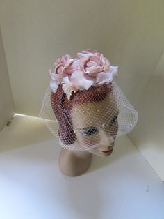 Oh so pretty!  A mid century, vintage whimsy hat or bridesmaid veil. The color is a subtle ashes of rose pink. Three fanciful roses are in organdy and velvet. The flocked veil is in pale pink and is nose length at 6". No maker label--union made label Size: 6 1/2 x 6 1/2 across the roses Condition: very good vintage, no stains, no holes Price: $22 #6443bb Vintage Headpieces For Wedding And Kentucky Derby, Vintage Wedding Headpiece For Kentucky Derby, Vintage Cream Fascinator For Wedding, Vintage Cream Headpiece For Wedding, Vintage Cream Wedding Headpiece, Vintage Cream Fascinator For Church, Cream Vintage Fascinator For Church, Vintage White Headpiece For Church, Vintage White Headpieces For Church