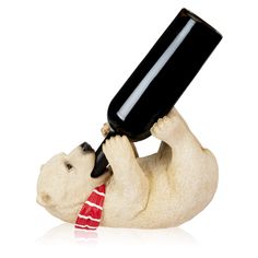 a statue of a polar bear holding a wine bottle in it's mouth,