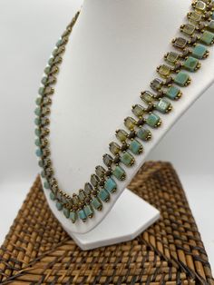 This handmade woven tile necklace is embellished with antique gold seed beads and brown superduo beads to highlight the green and turquoise brick beads.  This necklace can be worn with formal or casual wear. It's joined with a gold toggle clasp for easy attachment. Green Beaded Rectangular Necklace, Green Rectangular Beaded Necklace, Tile Necklace, Superduo Beads, West Sacramento, Turquoise Choker, Green And Turquoise, Woman Weaving, Toggle Clasp