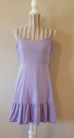 "size large dress has a boho style. It is unique and stylish. Laying the garment flat bust measures 38\" without stretching waist measures 30\" comfortably stretches to 36\". For a better visual, the mannequin's measurements are bust 34\" waist 25 ½\"." Fitted Mid-length Sundress, Summer Midi Mini Dress With Ruffles, Summer Ruffled Mid-length Mini Dress, Casual Knee-length Flowy Boho Dress, Fitted Summer Boho Dress, Fitted Knee-length Bohemian Sundress, Fitted Bohemian Knee-length Sundress, Bohemian Mini Sundress With Ruffle Hem, Casual Flowy Boho Mini Dress