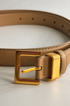 Front close up view of the Iris Taupe Slim Square Buckle Belt which features taupe Leather Fabric  and Gold Square Adjustable Buckle Chic Belts With Buckle Closure For Work, Chic Belts For Work With Buckle Closure, Gold Belts With Buckle Closure For Business, Chic Gold Belt With Buckle Closure, Elegant Formal Belt With Rectangular Buckle, Elegant Rectangular Belt Buckle For Workwear, Gold Belt With Rectangular Buckle, Chic Formal Belt With Rectangular Buckle, Elegant Adjustable Belts With Buckle Closure