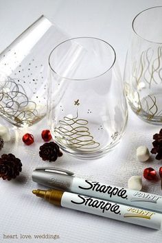 two pictures of wine glasses with christmas decorations on them