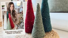 three crocheted christmas trees sitting on top of a white table next to a photo