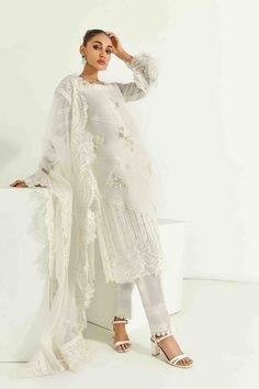 SKU: 1704 Price for Shirt lining and Pants Pure white silk net adorned with laces and hand embroidery of pearls, crystals, and resham and sequence work. The hemline is also adorned with organza and finished with lace details. The sleeves are made to perfection with lace details incorporated with self thread embroidery with cutwork. The gorgeous thread embroidered cutwork dupatta with 3D floral scattered all over can be added to this ensemble White Georgette Dupatta With Pearl Embroidery, Lace Sets With Pearl Embroidery For Wedding, Pearl Embroidery Lace Sets For Wedding, Elegant Lace Sets With Dupatta, Pearl Embroidered Lace Wedding Sets, Lace Wedding Sets With Pearl Embroidery, Cream Organza Sets With Lace Work, Elegant Cream Sets With Lace Work, White Organza Sets With Lace Work