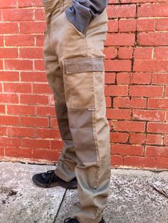 "Cargo pants, also sometimes called combat pants are loosely cut pants originally designed for rough work environments and outdoor activities, distinguished by numerous large utility pockets. Made of hard wearing fabric and ruggedly stitched, these are pants for all seasons and all activities Great for trekkers and hikers or for working outdoors in rain, wind, sun and shine As we say in Australia \"hard yakka\" - these epitomise hard yakka pants 🍺 W32\" x L41\" Jack is 180cm tall with a 30 inch waist Our vintage items reflect the style and trends of the 80s/90s and earlier eras. They are second-hand pieces and thus have been stored for some time, previously worn and owned.   They can be up to 30 years old. Because of this the item may arrive with signs of minor wear and tear, fading, mark Cargo Hose, Knee Cap, Combat Pants, Utility Pockets, 30 Years Old, 30 Years, All Seasons, Cargo Pants, Outdoor Activities