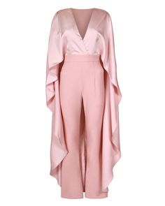 Get the look in our Blush Pink Jumpsuit with Satin Cape Detail. Designed with mixed fabrics, this jumpsuit with its fit and flare trouser detail is a must-have for your transitional wardrobe. Style with some nude heels for an elegant look this season. "Blush Pink Jumpsuit with Satin Cape Detail" Mixed fabric Satin top Waterfall cape detail Back zipper Crepe trouser Fit and flare trouser Cross neckline Polyester Machine wash Imported