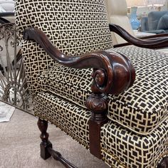 a chair that has been upholstered with black and white fabric