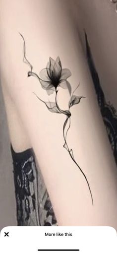 a black and white photo of a flower on the arm