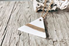 Handcrafted White and 14K Gold Matte and Glossy Triangle Porcelain Pendant Necklace - a unique and elegant piece of jewellery that combines the beauty of nature with a modern, minimalist design.  This necklace features a porcelain triangle pendant that has been hand-stained with coloured pigments to create a textured, tactile finish. The inspiration for this necklace comes from a hike I took in the beautiful Pyrenees mountain range in France, where the rugged peaks and natural beauty of the moun Minimalist White Triangle Jewelry, Dainty Triangle Jewelry Gift, Dainty Triangle Jewelry For Gifts, Minimalist White 14k Gold Filled Necklace, Handmade White Jewelry As A Gift For Her, Handmade Gold Triangle Jewelry, Minimalist Triangle-shaped Jewelry For Gifts, Minimalist Triangle Jewelry For Gifts, Triangle Shaped White Jewelry For Gifts