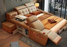 a bed that has been made into a couch with lots of pillows on top of it