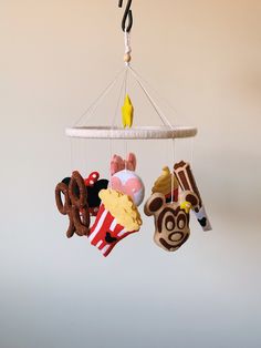 a mobile that has various items hanging from it's hooks and is decorated with cartoon characters