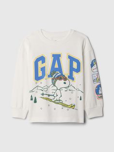 Soft cotton-blend T-shirt.  Crewneck.  Long sleeves with banded cuffs.  Gap logo with Peanuts holiday graphics at front.  Straight, easy fit.  Hits at the hip.  Sizes range from baby to toddler. Holiday T Shirts, Holiday Graphics, Sorority Merch, Elf Shirt, Gap Logo, Baby E, Brand Collaboration, Baby Gap, Toddler Gifts