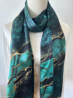 Vibrant and colorful natural mulberry silk long scarf with customized size of 170 cm x 55 cm / 68 in x 22 in. Gorgeous, velvety turquoise print, embellished with dreamy golden-copper streaks. One sided print, smooth and lustrous silk charmeuse, breathable and skin-friendly fabric feels very comfortable to wear. soft and lustrous fabric, light weight,breathable and skin-friendly feels very comfortable to wear. Can style this long scarf in different ways: wear the scarf as a neck scarf, as a long hair scarf, as a head wrap scarf, as an evening cover up...or style it any way you want with your own sense of creativity! Suitable for all seasons and a lovely gift idea for special occasions. Care Instructions: Pure silk is a type of organic, natural, and delicate fabric, please avoid washing. Dry Green Silk Scarf For Party, Gold Silk Scarf Shawl For Gift, Artistic Green Silk Scarf As A Gift, Green Shawl Scarf As Gift, Green Rectangular Scarf As Gift, Elegant Multicolor Silk Scarf For Festive Occasions, Green Rectangular Scarf For Gift, Elegant Green Scarves As Gifts, Green Rectangular Scarf Gift