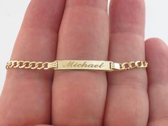 "Baby ID Name Bracelet Gold 14k Yellow Gold Cuban link. Perfect gift to a baby. This beautiful and stylish bracelet is great for both Birthday or Baptism. Surprise your loved ones with this unique bracelet and create the best memories together! Metal purity: Real 14k Gold , Stamped on the clasp Length: 6\" long adjustable to 5\" Width: 1/4\" or 5 mm wide on the ID and 3.0 mm wide on the Links Cuban links finish: Shiny links Weight: 2.20 grams Closure: Lobster clasp Engraving done in: #1- Script Baby Bracelet Gold, Name Bracelet Gold, Baby Bracelet, Stylish Bracelet, Jewelry Fashion Trends, Unique Bracelets, Name Bracelet, Cuban Link, Bracelet Gold