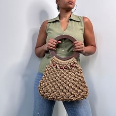 a woman is holding a purse in her hands