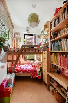 there is a bunk bed in the room with bookshelves and other items on the shelves