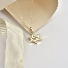 "With this stunning 14K Solid Gold Star of David Chai Pendant, you'll shine like a star. This stunning 18K Jewish Identity David Star Necklace is a timeless representation of life and tradition. This pendant is made of exquisite pure gold and includes a delicate six-pointed star carved with detailed embellishments. The Hebrew word \"life\" is represented by the chai sign in the center, making this a memorable gift for any occasion. Whether you're honoring your faith or reconnecting with your heritage, this beautiful necklace's basic yet elegant design will enhance any look. Give the gift of tradition this holiday season with this handcrafted piece of Jewish jewelry. Details of the product Material: 14K and 18K Solid Gold Elegant Gift For people whom you love; Mom, Girlfriend, Wife, Fiance, Jewish Symbol, David Star, Jewish Symbols, Symbol Of Life, Jewish Jewelry, Jewelry Details, Life Symbol, Star Of David, Gold Star