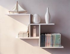 a shelf with books, vases and other items on it