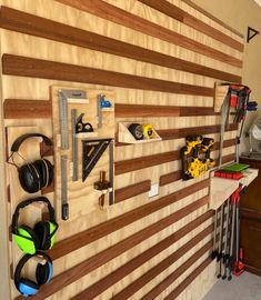 there is a wooden wall with many items on it and earphones hanging from the side