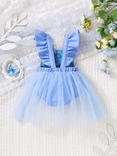 Introducing our stunning Newborn Infant Baby Girl Blue Faux Sequin Print Ruffle Ice Princess Bodysuit. This adorable outfit features faux sequin print, ruffle details, and a butterfly bow, creating a whimsical and enchanting look. The tulle shirt adds an extra touch of elegance. Crafted with comfort in mind, this bodysuit ensures a soft and cozy fit for your little princess. Perfect for special occasions or everyday wear, this outfit is a must-have addition to your baby girl's wardrobe. Shop now Summer Tutu Dress With Bow For Baptism, Summer Baptism Tutu Dress With Bow, Summer Tutu Dress With Bow For Dress-up, Blue Fitted Bubble Romper For Spring, Fitted Blue Bubble Romper For Spring, Spring Fitted Blue Bubble Romper, Summer Party Bubble Romper With Ruffles, Spring Party Bubble Romper With Ruffles, Fitted Bubble Romper For Summer Party