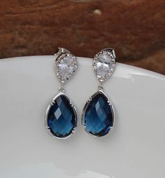 these beautiful earring made of blue glass drop , and finished with sterling silver post . drop Montana earring are 1.5 '' long from top to bottom. cz stone are 18mm for more https://www.etsy.com/shop/arbjewelry