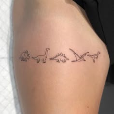 a woman's thigh with three dinosaurs on it