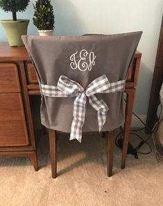 a chair with a monogrammed bow on it