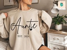 Custom Auntie Est Sweatshirt, Auntie Sweatshirt, Auntie Gift, Aunt Shirt, Christmas Gift Auntie, Mother's Day Sweatshirt, Mothers Day Gift -----How To Order----- 1-) Please, check and review all photos 2-) Choose your t-shirt size and color *Different styles of shirts may have different shades of same color choice due to different manufacturer brands. *For this reason, we recommend you to match shirts from the same styles if you want precisely matching colors (exa. Unisex, V-neck, Tank top, etc.). 3-) Click add to cart. You can go back to add more product 4-)Click "Proceed to check out" 5-)When you check out, you can add a note to seller for any request. ---------- Product ---------- * 4.2 oz., 100% airlume combed and ringspun cotton, 32 singles * 32 singles Athletic Heather and Black Heat Auntie Sweatshirt, Aunt Sweatshirt, Aunt Shirt, Auntie Shirts, Aunt Shirts, Auntie Gifts, Matching Colors, Color Choices, Color Matching