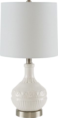 a white table lamp with a white shade on it