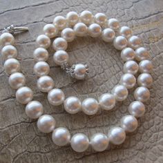 Designer Costume Fashion Classic 8 MM Pearl Bead Necklace, Pearl & Rhinestone Clasp, Signed N, Napier. Iconic Traditional Pearl Fashion Necklace, vintage, gently worn, I see one tiny rhinestone missing on the cap of the clasp, I can only see it under a loupe. NOTE: Length is 15 7/8 IN, not quite 16 IN  8 MM beads, or just slightly over 1/4 IN N is likely for Napier, it is a N logo in a circle  Classic Style Hand strung and knotted with white thread/silk  White pearls, costume/faux or fashion / n Pearl Necklaces With Rhinestones For Gift, Classic White Rhinestone Necklace, Classic White Necklace With Rhinestones, Classic Pearl White Beaded Necklaces For Jewelry Making, Elegant Beaded Necklaces With Rhinestones For Jewelry Making, Elegant Party Necklace With 8mm Beads, Elegant Adjustable Necklace With 8mm Beads, Logo N, Pearl Bead Necklace