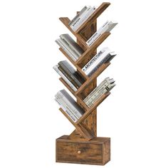 a wooden book stand with several books on it's sides and two stacks of books in the middle