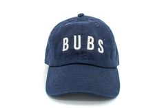 Navy Bubs Hat | Toddler Boy Hats - Rey to Z Blue Cotton Snapback Hat With Embroidered Logo, Navy Cotton Hat With Logo Patch, Blue Embroidered Cotton Dad Hat, Adjustable Blue Hats With Embroidered Patch, Blue Cotton Trucker Hat With Letter Print, Blue Pre-shrunk Hat With Curved Brim, Customizable Blue Baseball Cap With Curved Brim, Blue Cotton Snapback Fitted Hat, Blue Cotton Fitted Hat