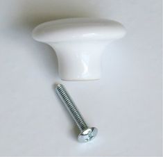 a white door knob and screw on a white surface