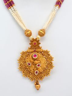 This beautiful antique gold pendant features Kemp stones and American diamonds, paired with a Pearl Mala Necklace and earrings set. This exquisite necklace enhances your style for any occasion, adding sparkle whether you wear it with a dress or a stunning saree. Necklace Length: 11.5" and can be adjusted with a chain. Earring length: 1.5" with push-back closure Antique gold Polish and High-quality brass as the base metal Availability: In-Stock. *Color may vary slightly due to light condition & p 22k Gold Pearl Necklace For Celebrations And Festivals, Gold Pearl Necklace With Intricate Design For Diwali, Diwali Gold Pearl Necklace With Intricate Design, White 22k Gold Kundan Necklace With Intricate Design, Festive Gold Bridal Necklace With Pearl Pendant, Temple Jewelry Style Necklace With Tilla For Anniversary, Temple Jewelry Pearl Necklace With Pendant, Traditional Festive Jewelry Set With Pearl Pendant, Gold Bollywood Necklace With Pearl Pendant