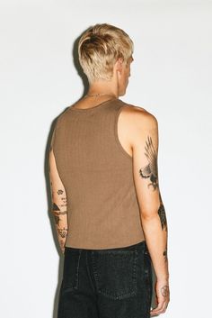 A 90s minimalist silhouette updated with a crop that hangs at the waistband. The heavyweight 2-ply, ribbed cotton has a sculptural look and feel to allow for the tank to be worn solo as a statement alone. Stretch Ribbed Tank Top For Streetwear, Modern Cropped Top For Everyday Wear, Casual Ribbed Crop Top For Streetwear, Guy Outfits, Minimalist Silhouette, Denim Belt, Western Leather, Sweatshirt Shirt, Body Fit