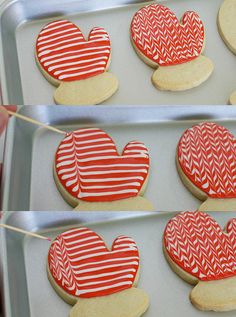 cookies decorated with red and white icing in the shape of hearts are on display