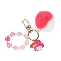 a key chain with a pom - pom attached to it and a hello kitty charm