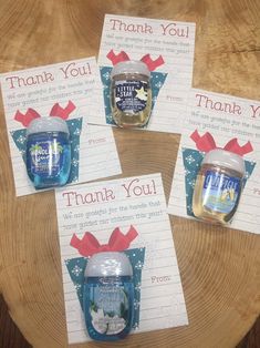 four thank you cards with blue jars and red bows are on top of a wooden table