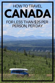 a blue van parked on top of a lush green field next to trees and mountains