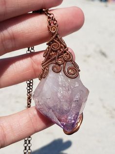 Beautiful handmade copper wire wrapped amethyst crystal point. Comes with a copper plated steel chain. Often viewed as a stone of peace, some believe amethyst's calming presence produces soothing dreams by bringing the dreamer more in tune with the Divine. This clarity and peacefulness also extends to the waking mind. Amethysts are said to help the mind flow freely in both mental and metaphysical dimensions. Copper Wire Pendant Crystal Necklace For Healing, Purple Amethyst Wire Wrapped Crystal Necklace, Unique Wire Wrapped Crystal Necklaces For Healing, Unique Wire Wrapped Amethyst Necklaces, Unique Amethyst Wire Wrapped Necklaces, Spiritual Copper Necklace For Healing, Bohemian Copper Wire Wrapped Crystal Necklaces, Bohemian Wire Wrapped Amethyst Necklace, Wire Wrapped Amethyst Necklaces For Meditation