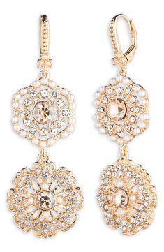 Sparkling crystals and imitation pearls illuminate glamorous double-drop earrings finished in glossy goldtone plate. 2 1/2" drop; 3/4" width Lever-back closure Goldtone plate/glass/acrylic imitation pearl Imported Gold-tone Glamorous Earrings For Formal Occasions, Glamorous Gold-tone Earrings For Formal Occasions, Glamorous Gold-tone Formal Earrings, Elegant Gold-tone Crystal Drop Earrings, Glamorous Gold Pearl Jewelry, Gold-tone Pearl Drop Earrings For Party, Glamorous Gold Dangle Pearl Earrings, Gold Crystal Chandelier Earrings For Formal Occasions, Gold Pearl Chandelier Earrings For Evenings