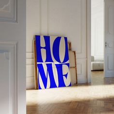 a blue and white sign sitting on top of a hard wood floor next to a doorway