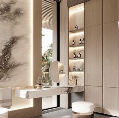 an elegant bathroom with marble walls and flooring, along with white stools in front of the vanity