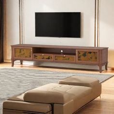 a living room scene with focus on the entertainment center and large screen tv above it