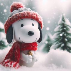 a snoopy dog wearing a red hat and scarf in the snow