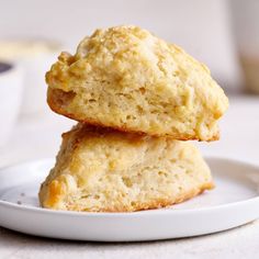 two biscuits stacked on top of each other on a white plate