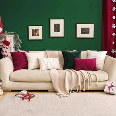 a living room filled with furniture and christmas decorations