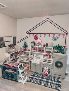 a room filled with lots of christmas decorations and decor on the walls, including an oven