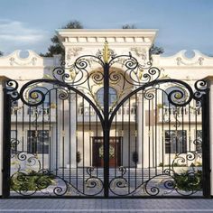 an iron gate is open in front of a large white building with columns and arches